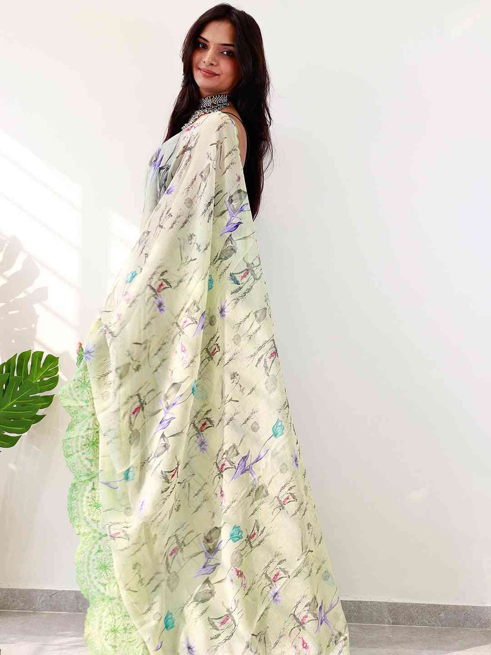 Elegant chiffon satin saree with floral design and green cut work border.