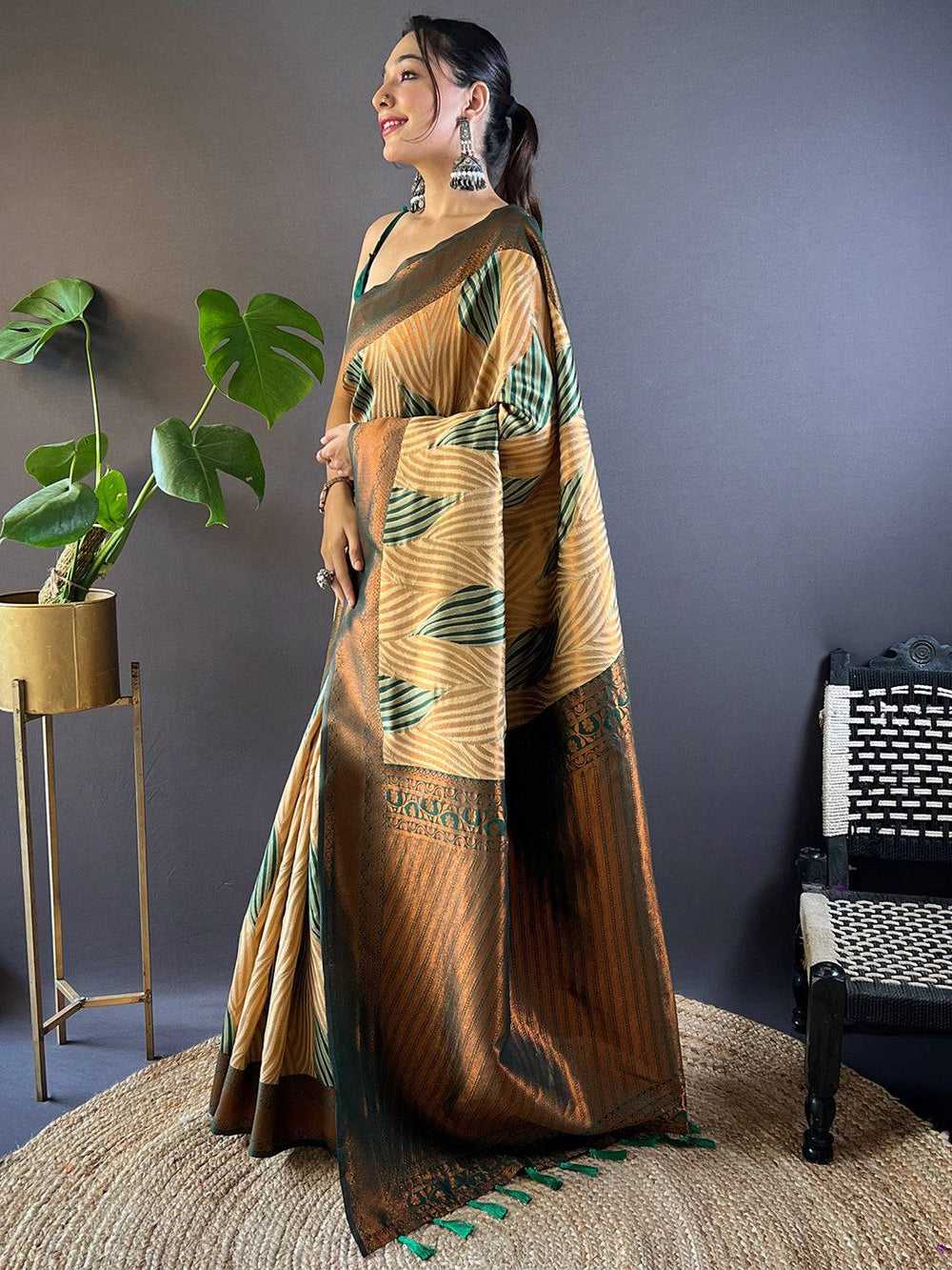 Side pose of model in brown Tussar silk Ikkat saree.