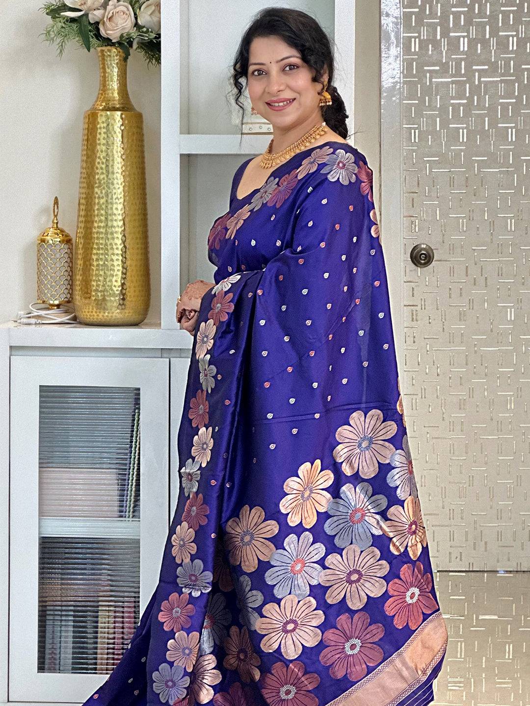 Side view of purple silk saree with intricate floral patterns