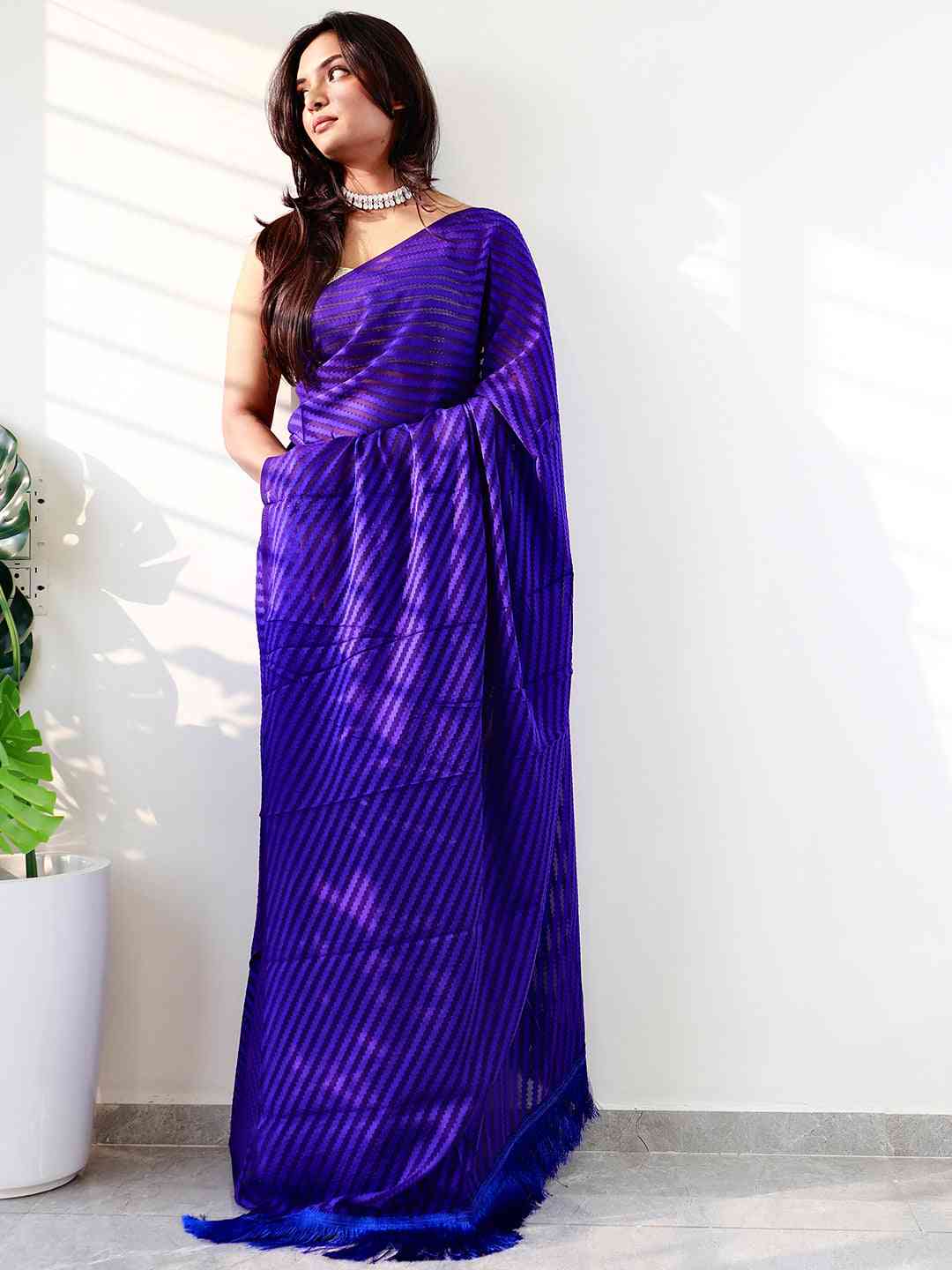 Stylish blue georgette saree showcasing thread weaving design