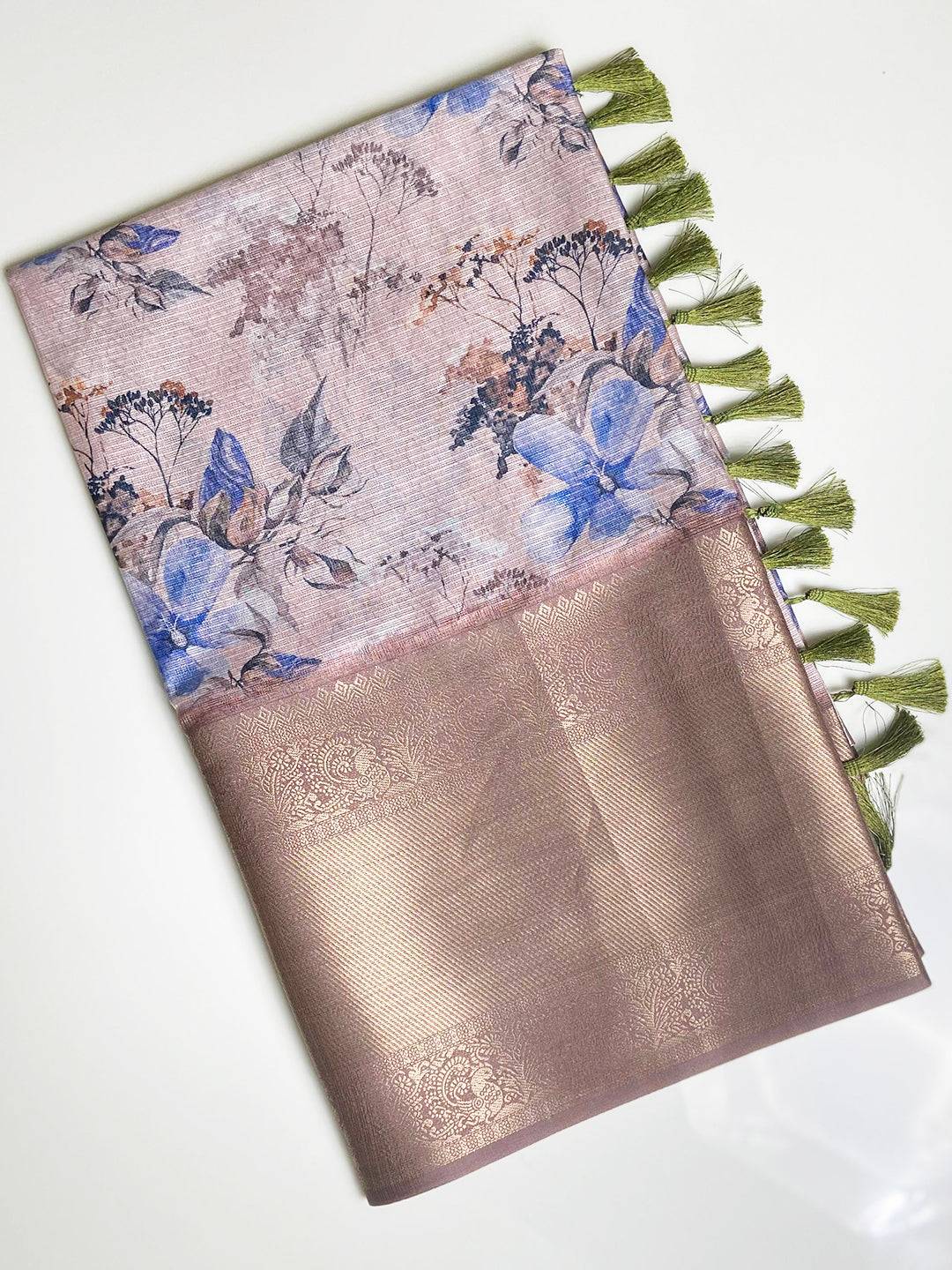 Folded light pink saree with floral design and gold zari border