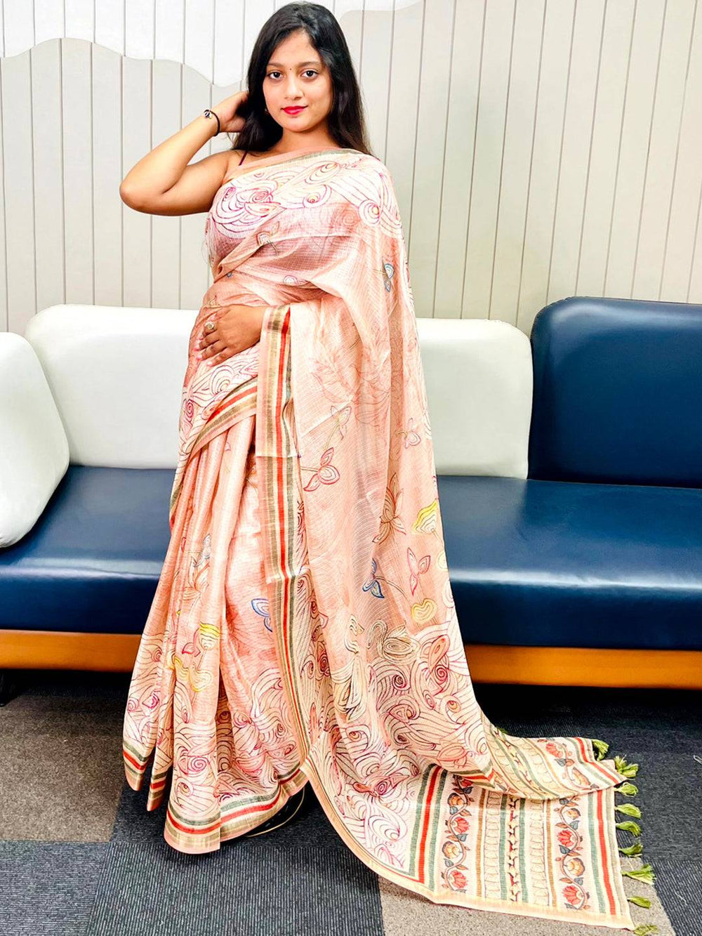 Model showcasing peach Kota Doriya silk saree with floral Kalamkari design.
