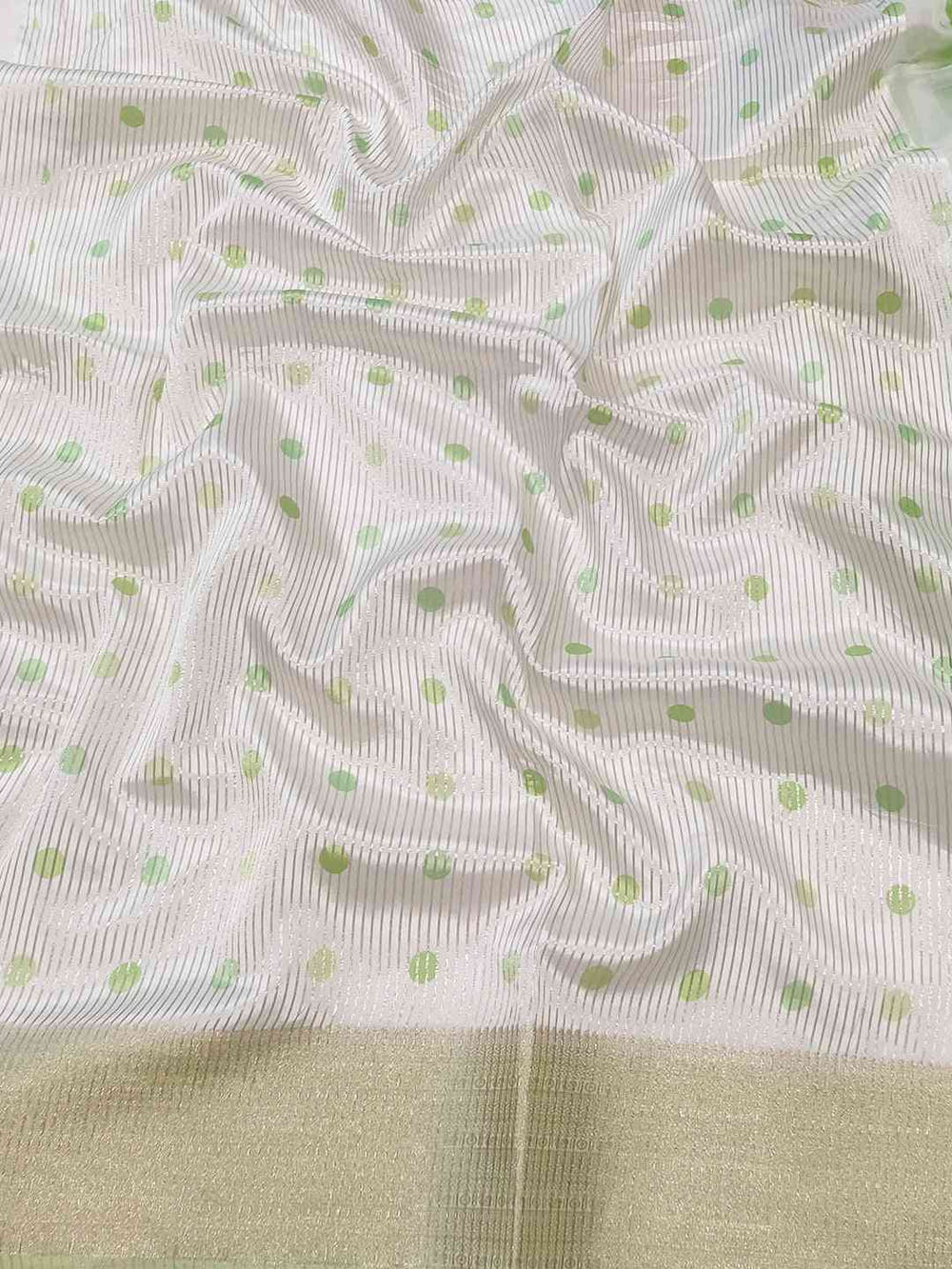 Detailed view of organza saree with green polka dots