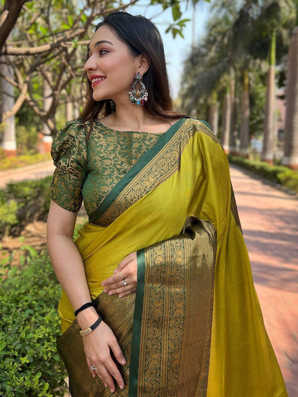Woman in light green Kanjivaram saree with intricate weaving