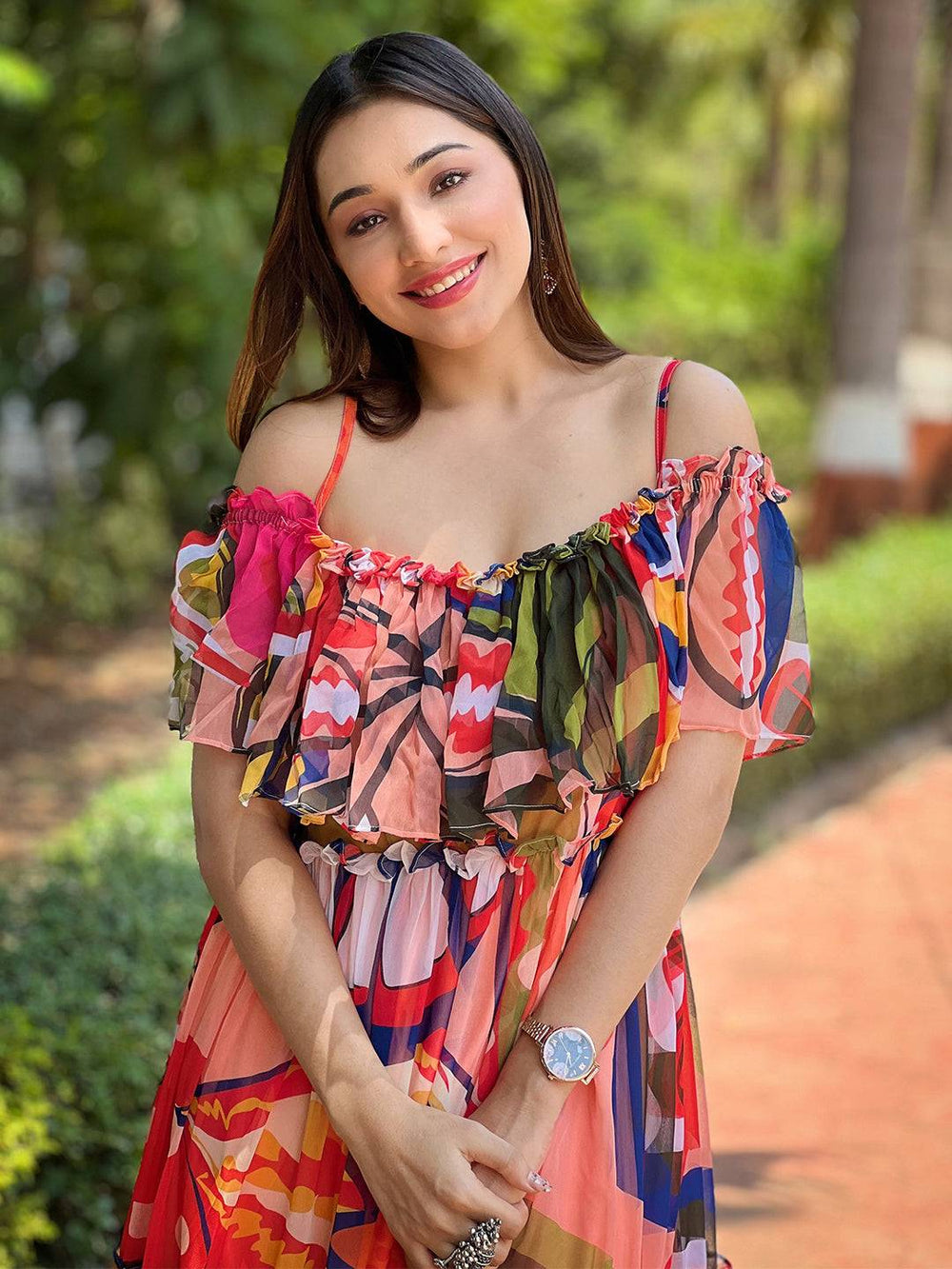 Smiling woman in tropical print off-shoulder dress