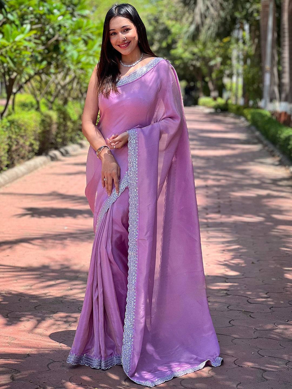 Model wearing Salvia Lavender Viscose Saree on a path
