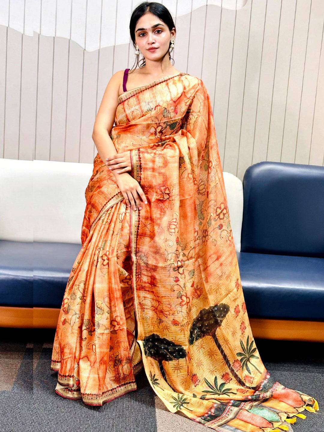 Model showcasing orange Kota Doriya silk saree with floral design.