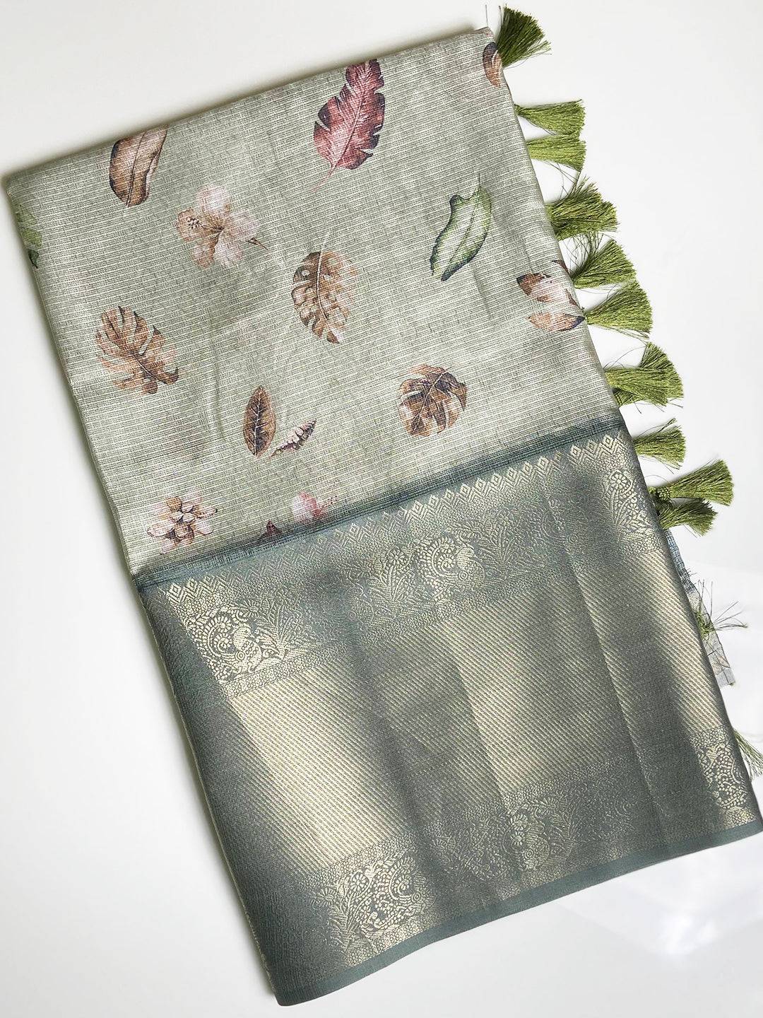 Elegant green saree with Kanjivaram gold zari border and tassels