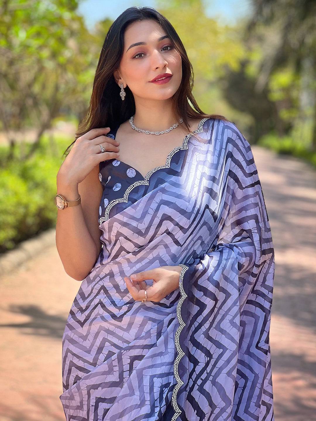 Elegant Leheriya and striped print saree in outdoor setting