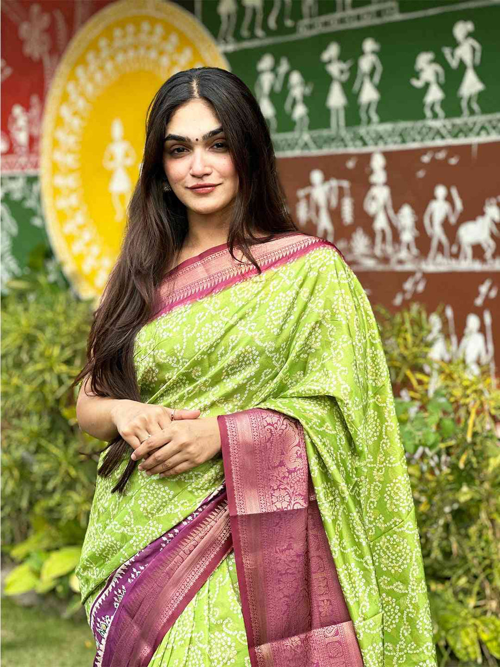 Close-up of green Bandhej saree with pink Zari border