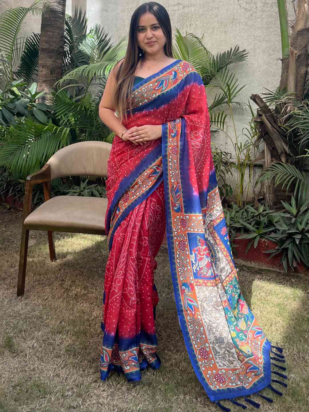 Red linen saree with Bandhej and kalamkari print, standing pose