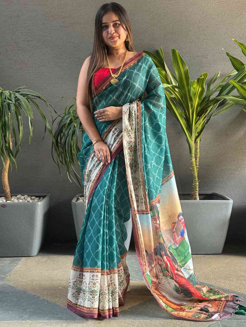 Teal Ikkat saree with kalamkari design, standing view