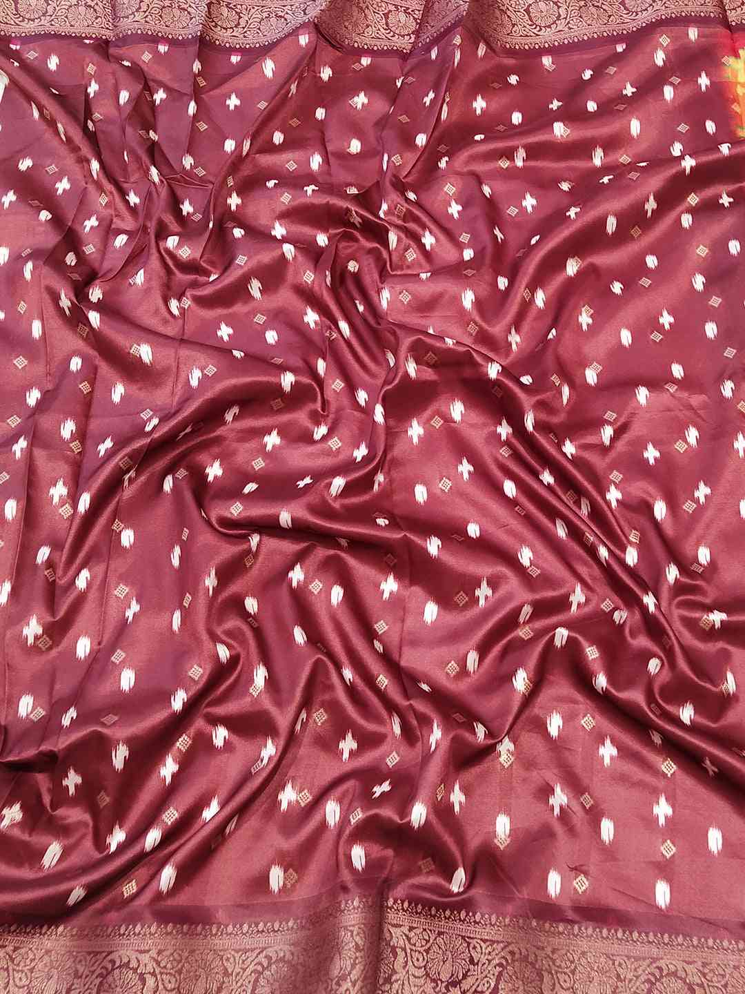 Rich maroon Banarasi soft silk fabric with delicate zari patterns