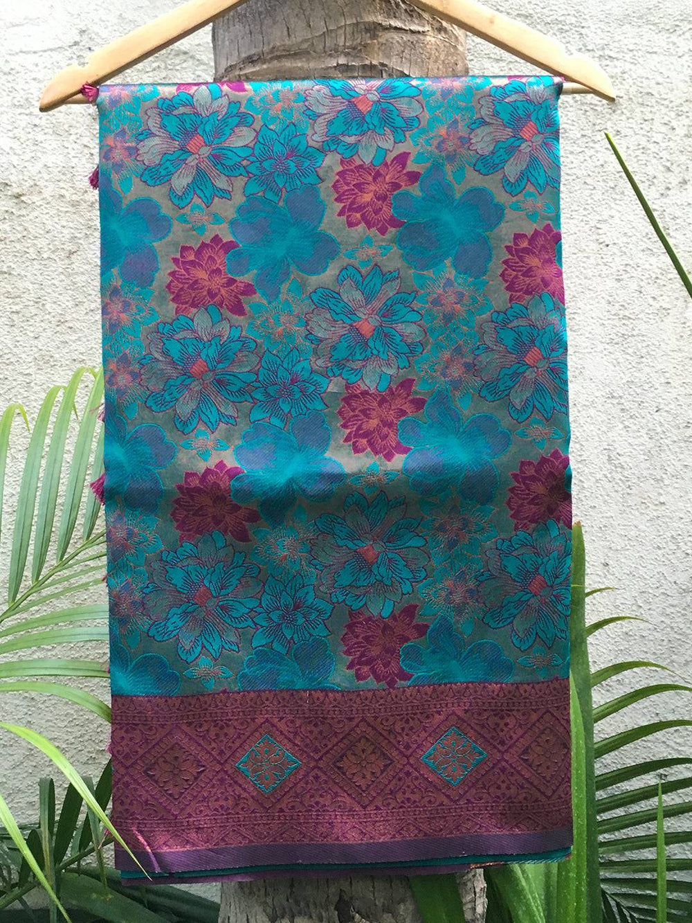 Teal Soft Silk Butta Weaving Saree displayed on hanger