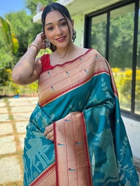Woman wearing teal Paithani silk saree with intricate pichwai design
