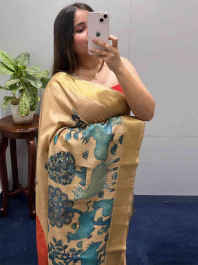 Close-up of Kalamkari linen tissue saree with artistic motifs.