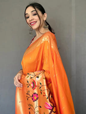 Close-up of orange Paithani saree with zari woven details