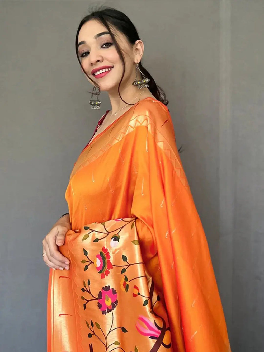 Close-up of orange Paithani saree with zari woven details