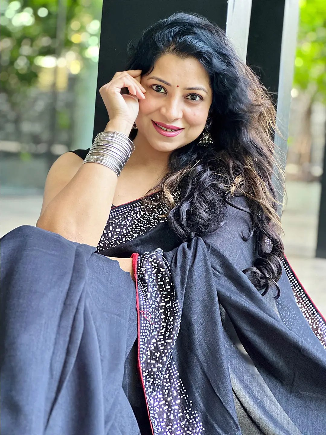 Model in black saree with shimmering embroidery