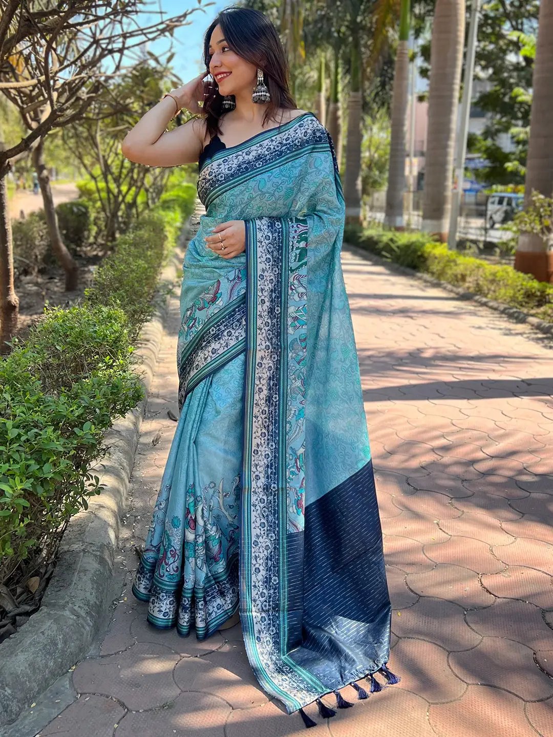 Turquoise Satin Kota Doria Saree with Kalamkari print worn by a model.
