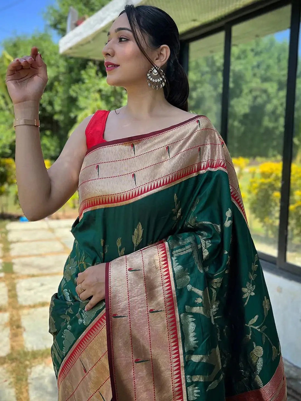 Woman wearing dark green Paithani silk saree with red blouse