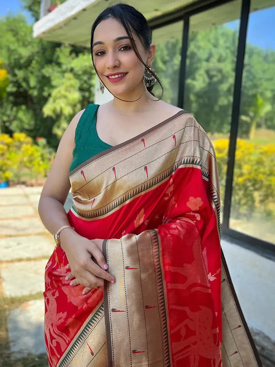 Woman in red Paithani silk saree with gold border outdoors