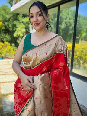 Woman in red Paithani silk saree with gold border outdoors