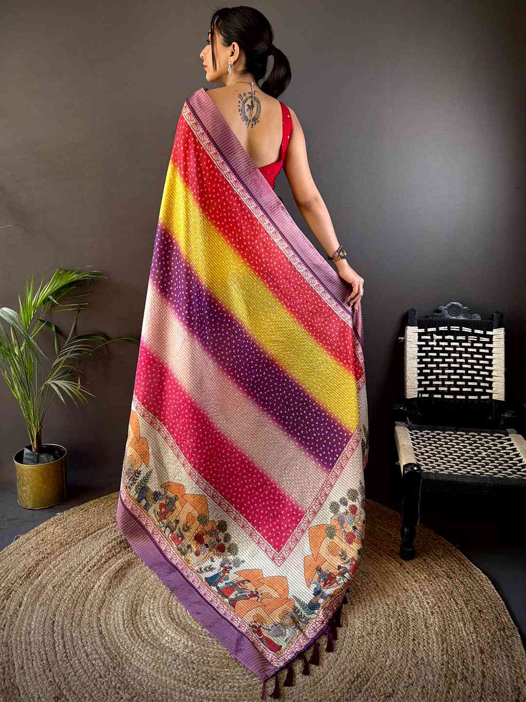 Back view of Artful Silk Blend Bandhani Print Saree showcasing bold diagonal stripes and intricate border designs, perfect for festive wear.