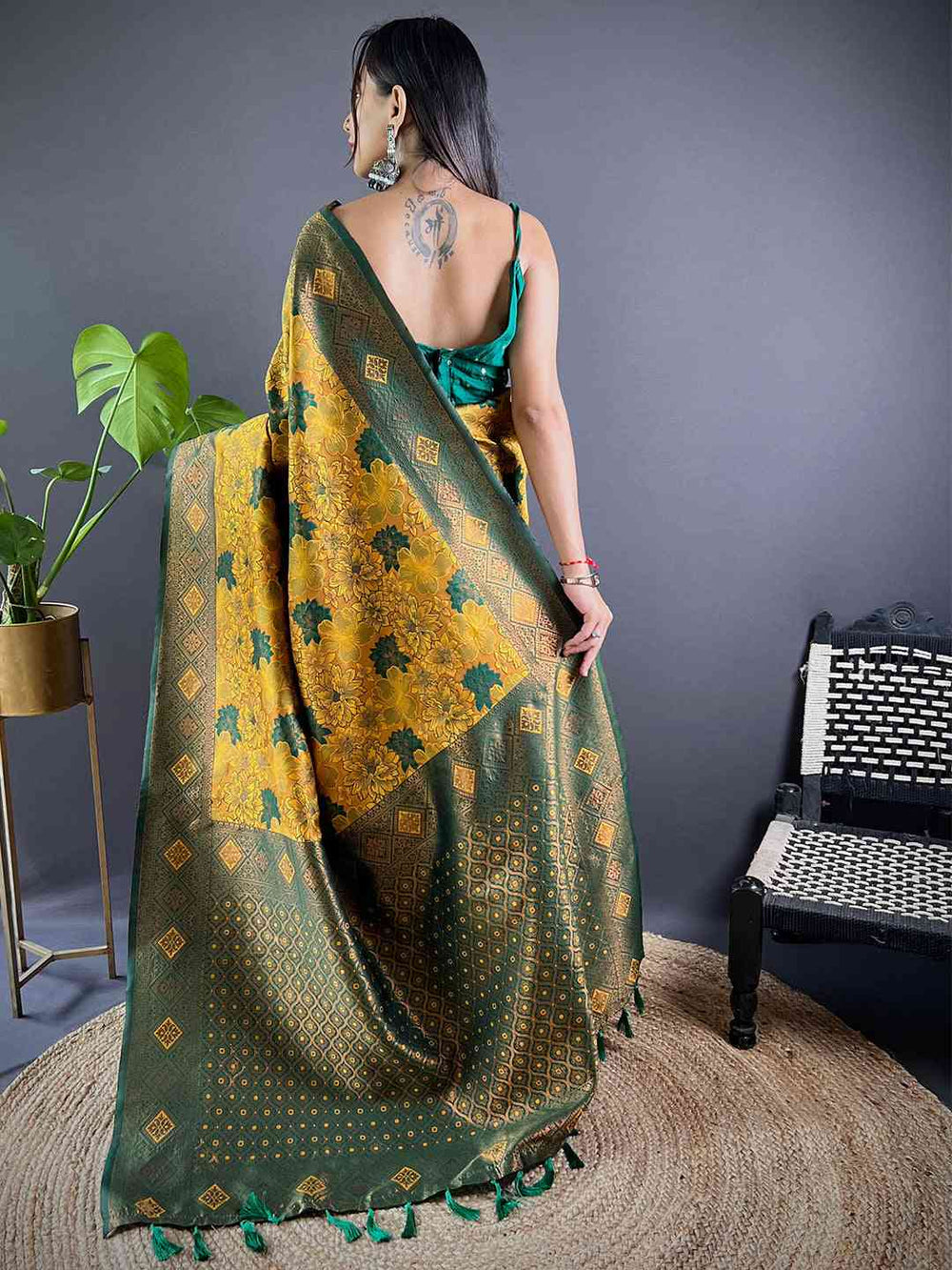 Back view of mustard silk saree with green floral butta weaving.