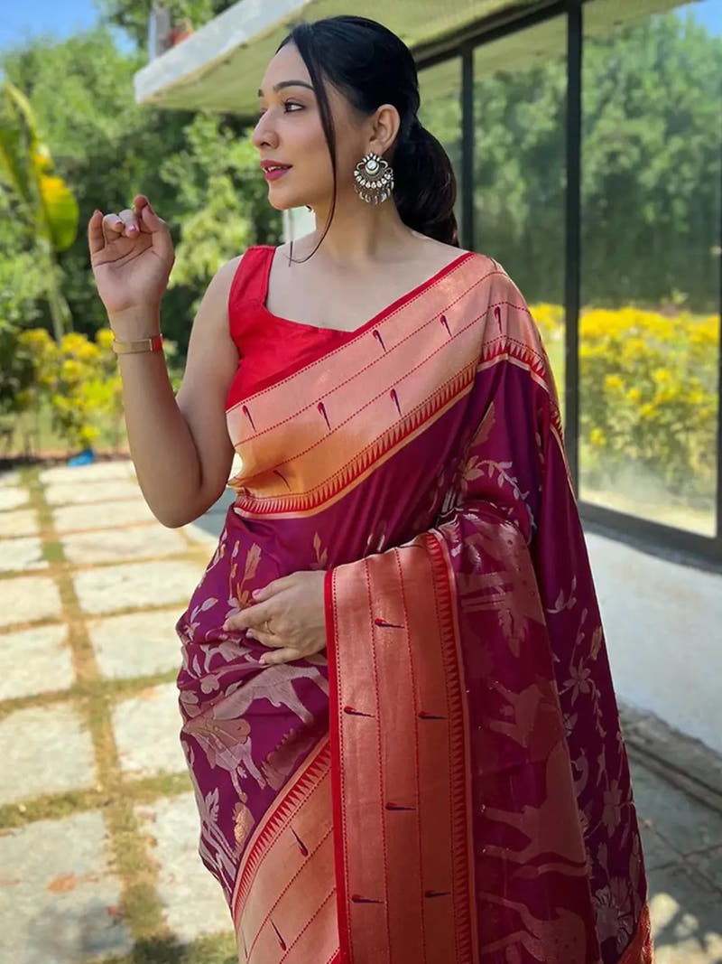 Woman in magenta wine Paithani silk saree outdoors
