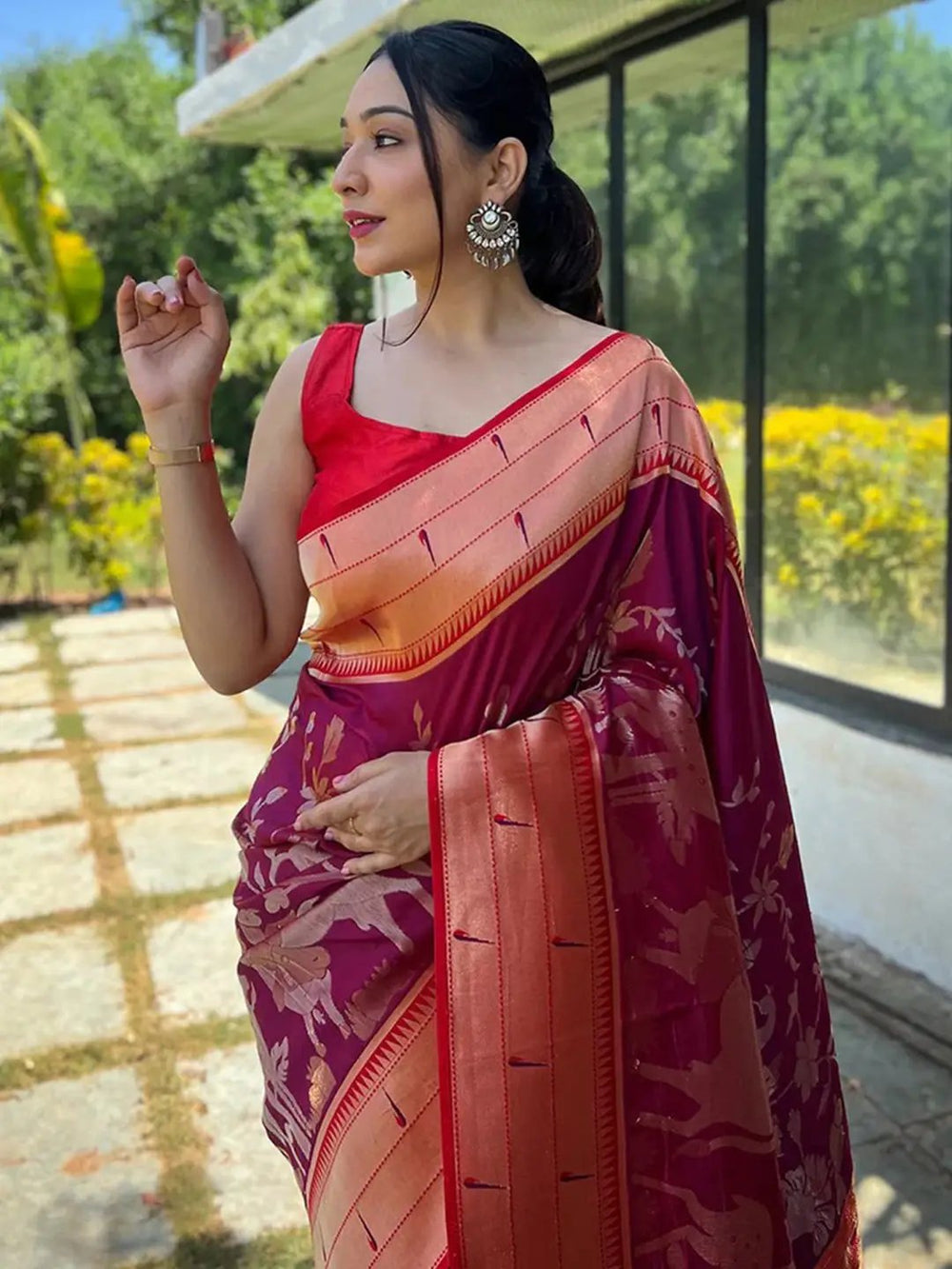 Woman in magenta wine Paithani silk saree outdoors