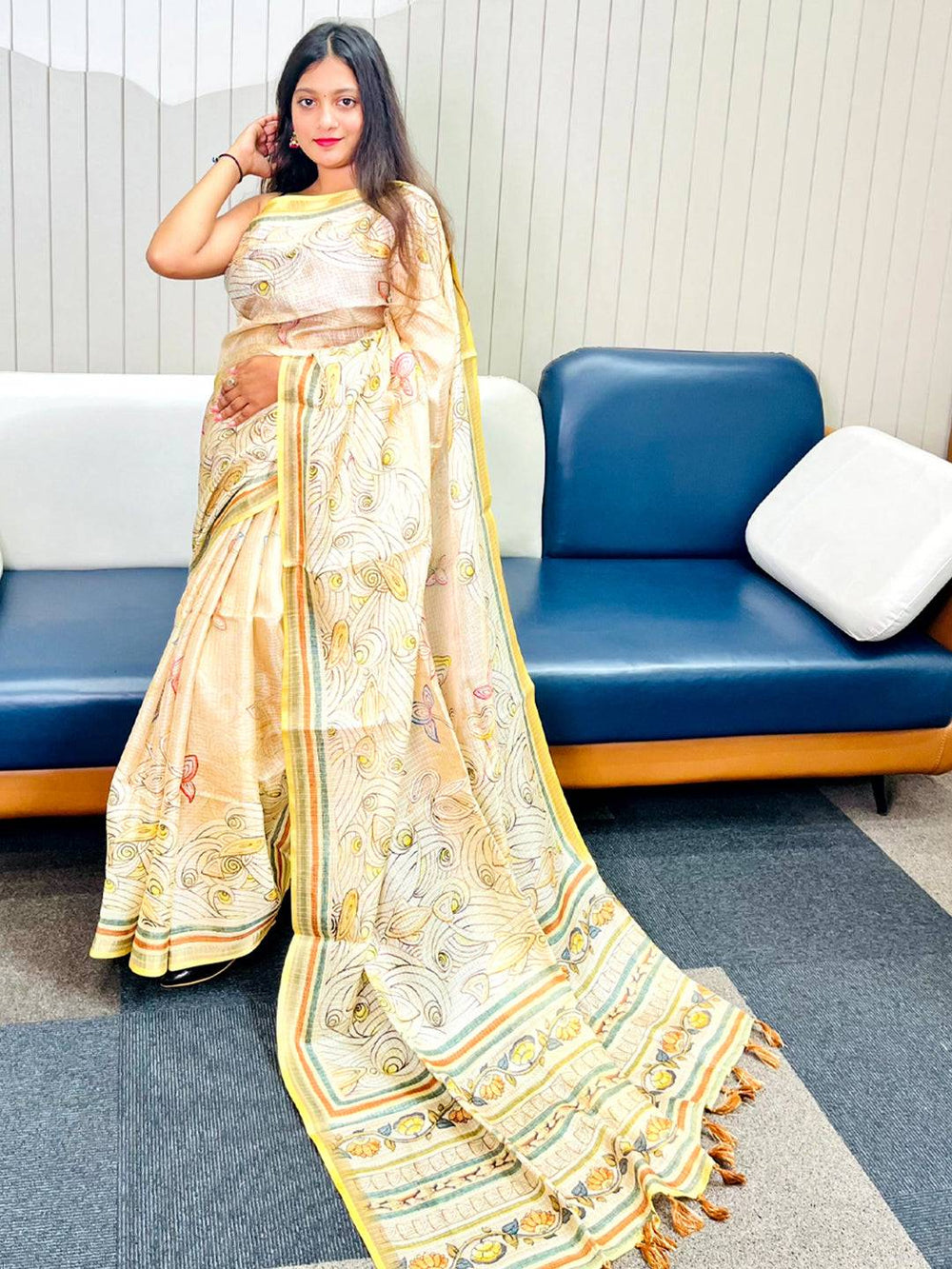 Model showcasing yellow Kota Doriya silk saree with floral Kalamkari design.