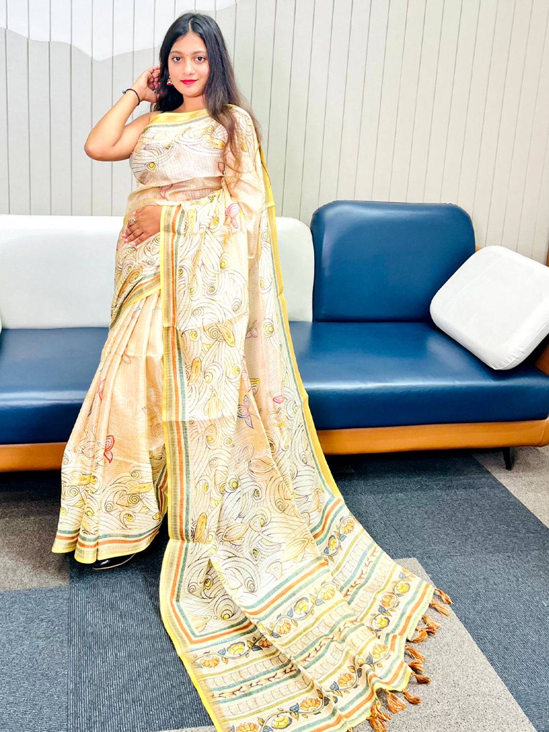 Model showcasing yellow Kota Doriya silk saree with floral Kalamkari design.