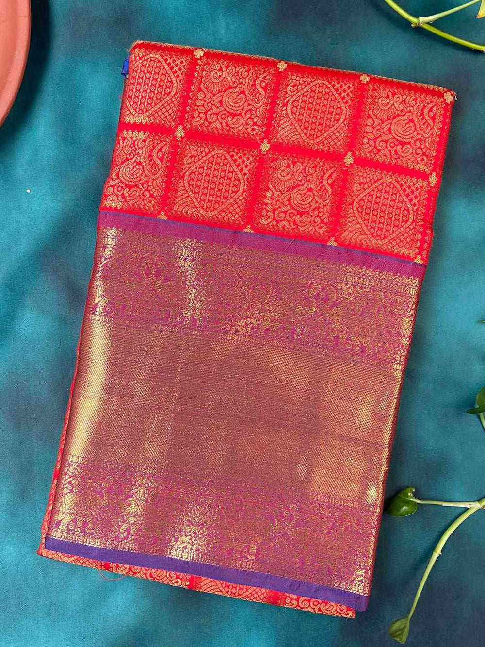 Red Kanjivaram silk saree with checked print folded