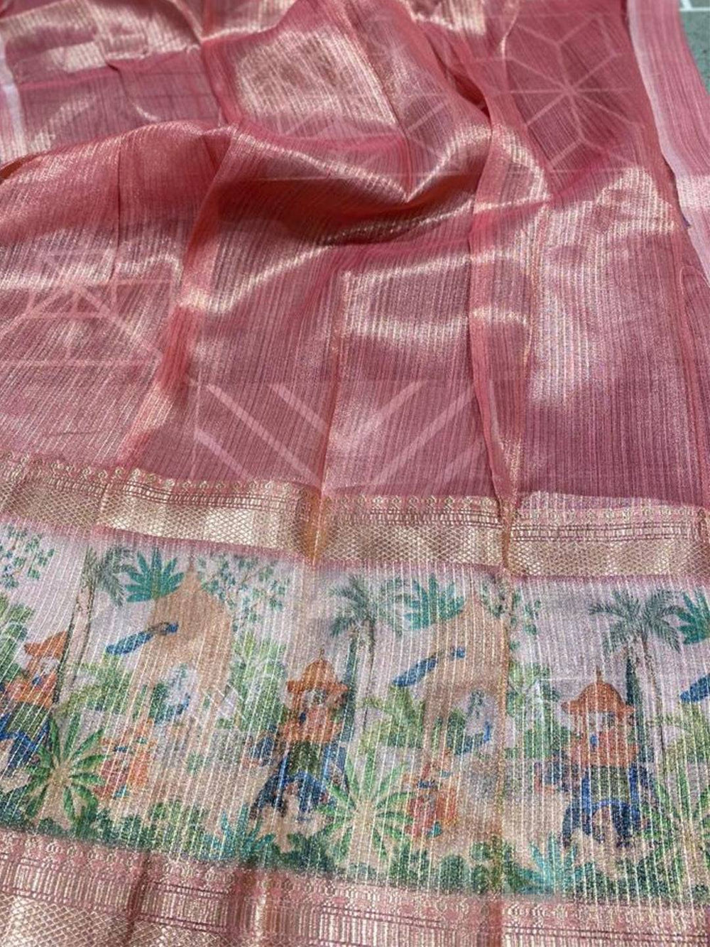Close-up of soft gold zari tissue saree showcasing detailed digital print.