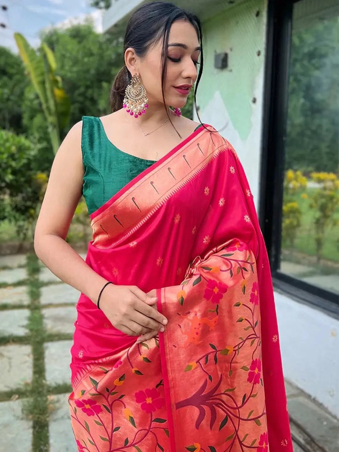 Close-up of pink Paithani saree with floral design and big border