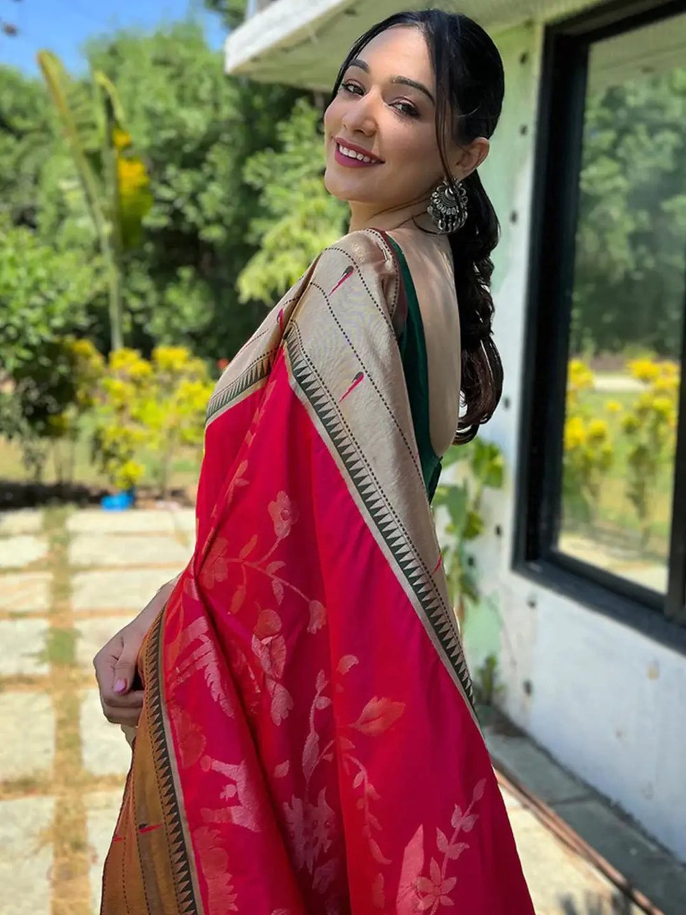 Model wearing pink Paithani silk saree with floral motifs
