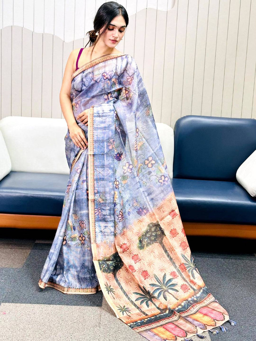 Model showcasing blue Kota Doriya silk saree with floral design.