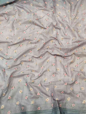 Close-up of grey saree fabric with floral and zari chex