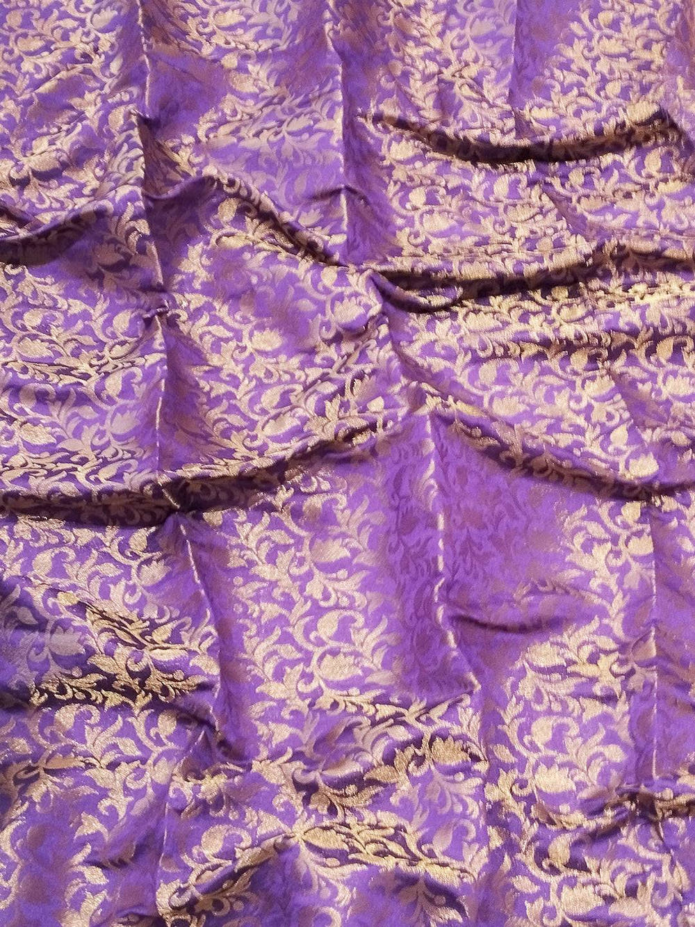 Close-up of purple brocade zari blouse fabric design