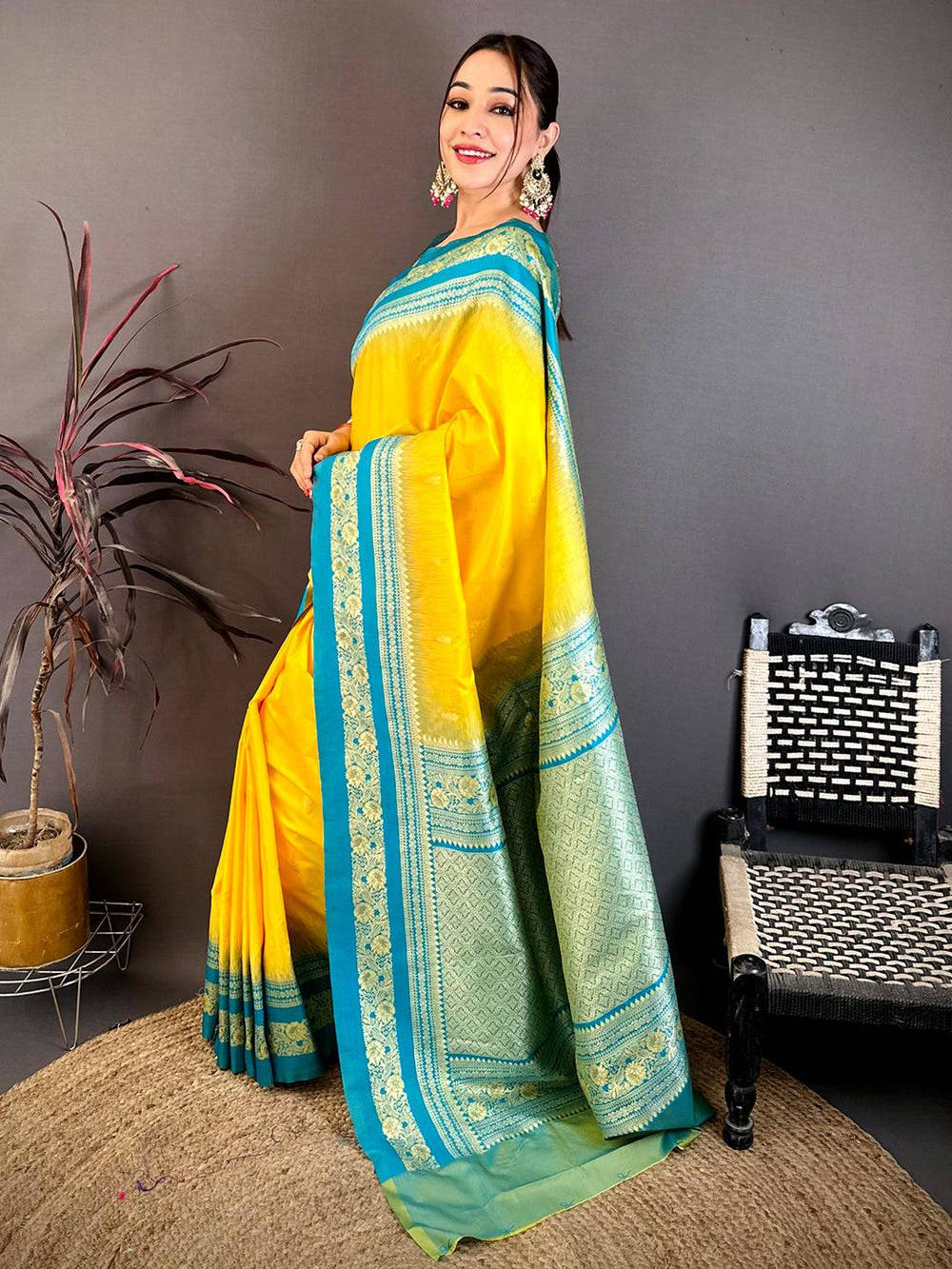 Close-up of yellow and blue silk saree with gold zari border, showcasing detailed craftsmanship and vibrant colors