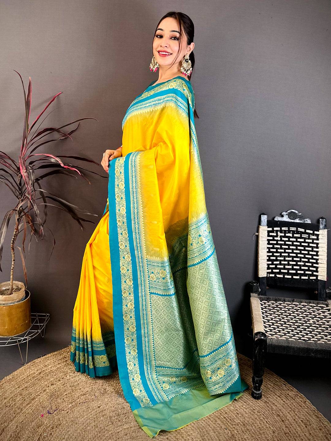 Close-up of yellow and blue silk saree with gold zari border, showcasing detailed craftsmanship and vibrant colors