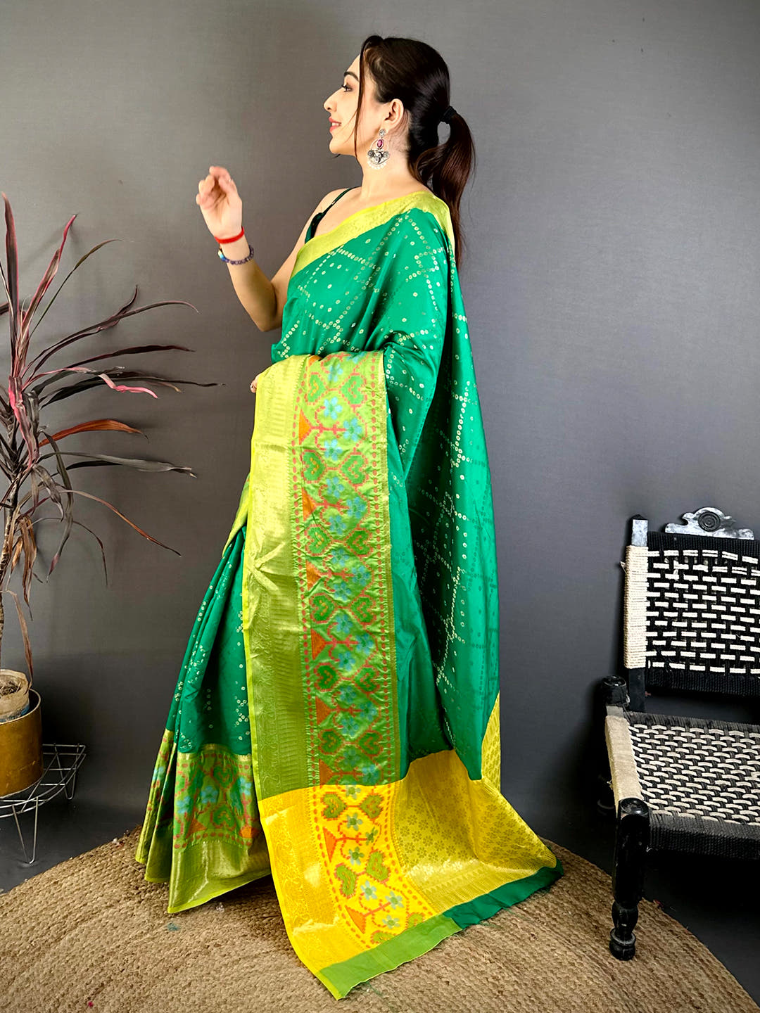 Close-up of yellow and green Banarasi saree fabric with floral motifs