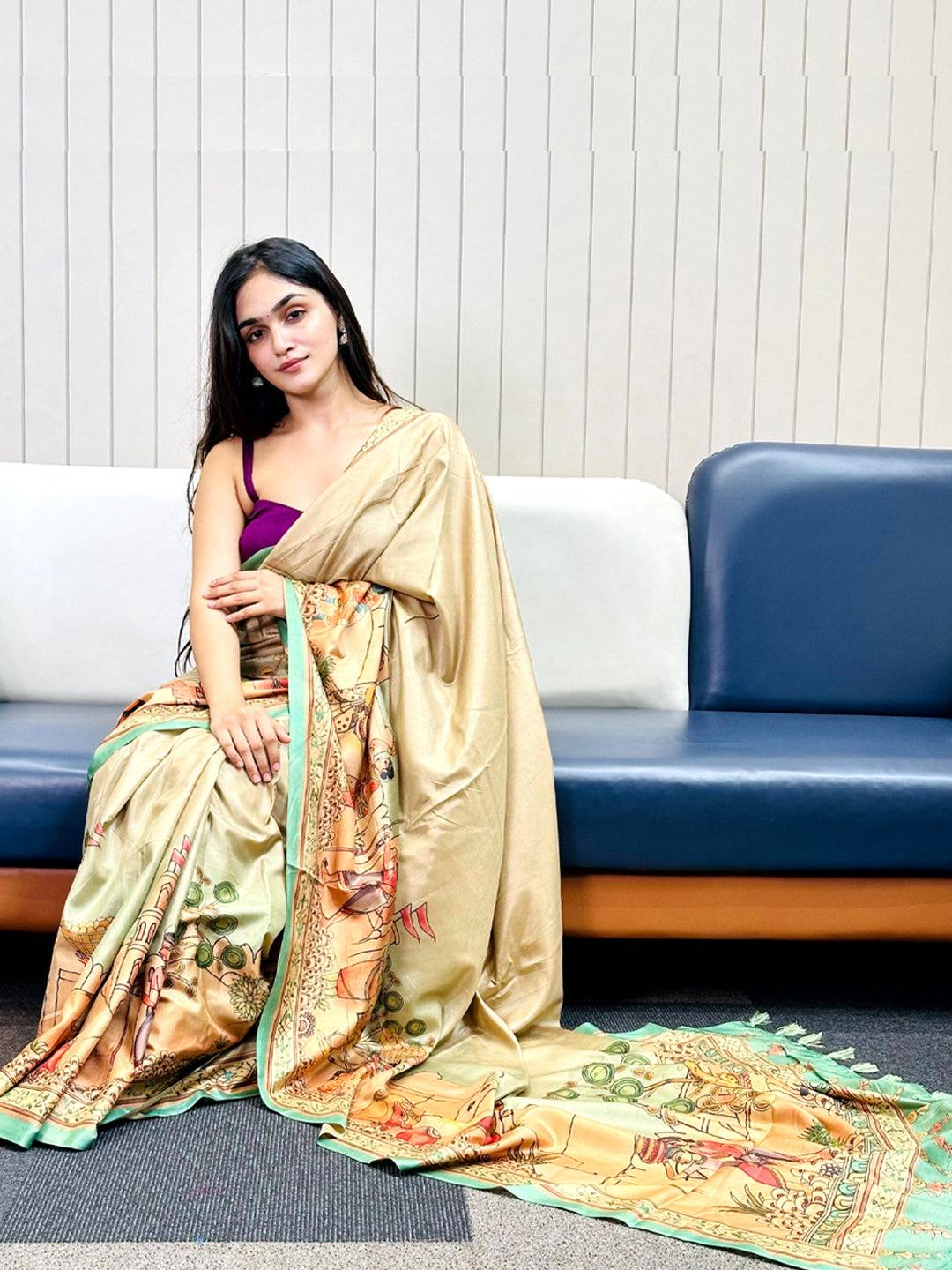 Model seated wearing Green Free Hand Kalamkari Print Saree with detailed artwork.