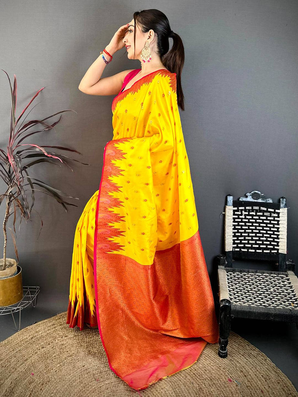 Close-up of yellow silk saree with detailed zari work and vibrant border