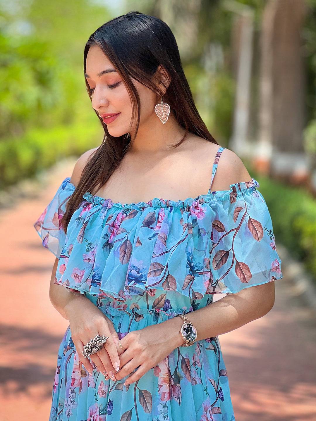 Woman posing in blue floral maxi dress