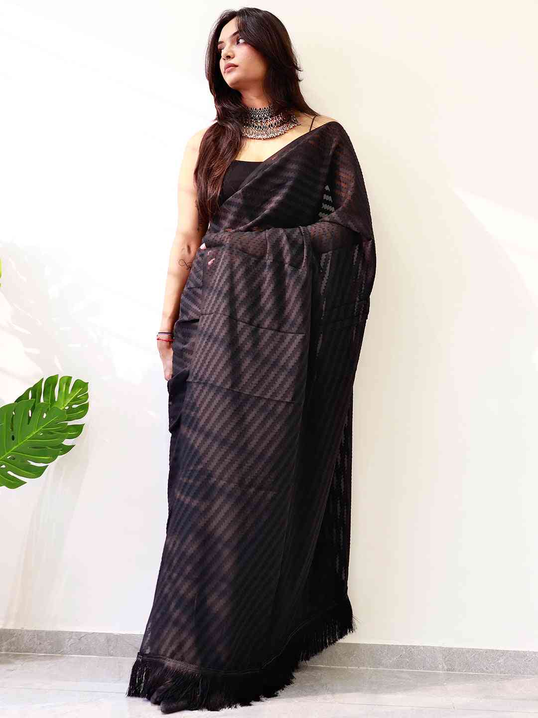 Stylish black georgette saree showcasing intricate weaving
