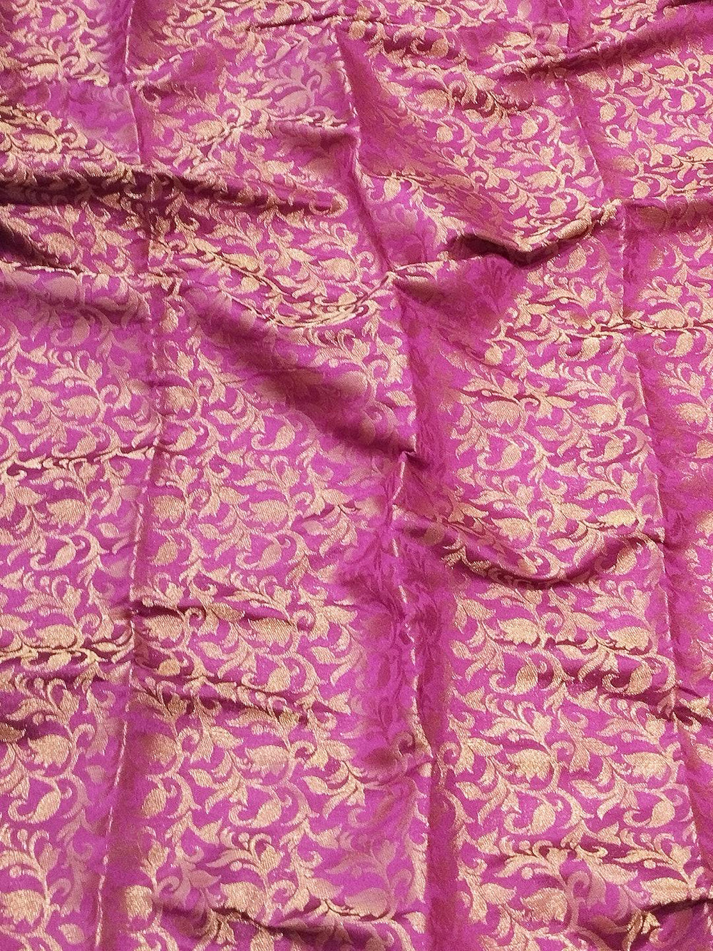 Close-up of pink brocade zari fabric design
