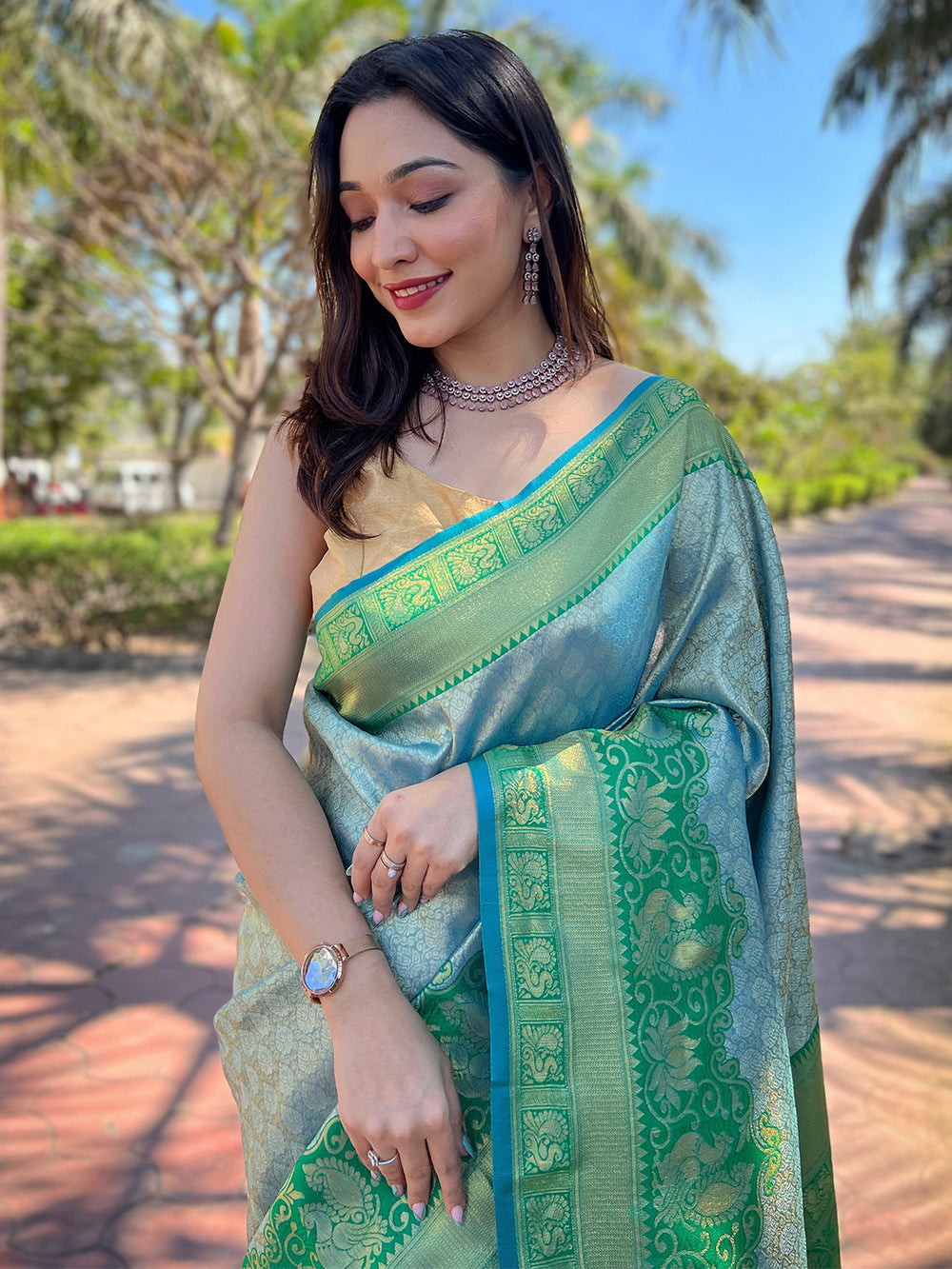 Model showcasing green Kanjivaram silk saree with jewelry