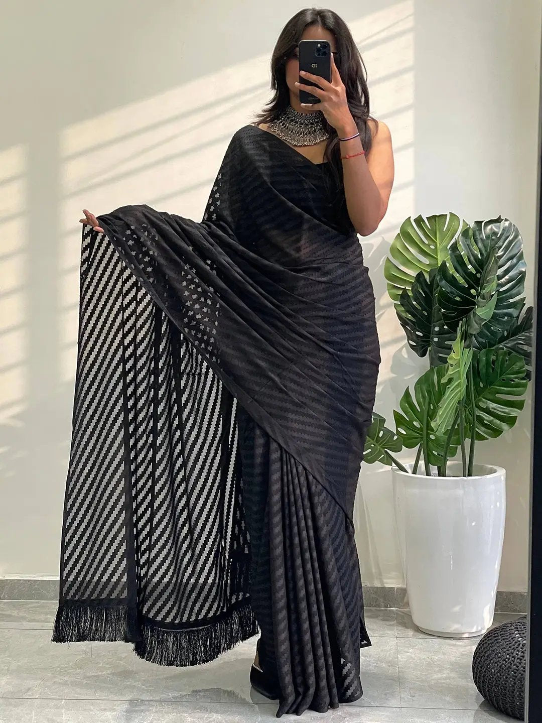 Black georgette saree with detailed thread weaving pattern